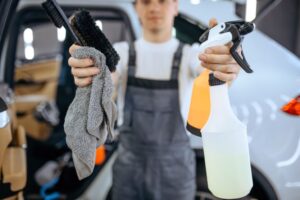 worker-shows-tools-for-dry-cleaning-and-detailing